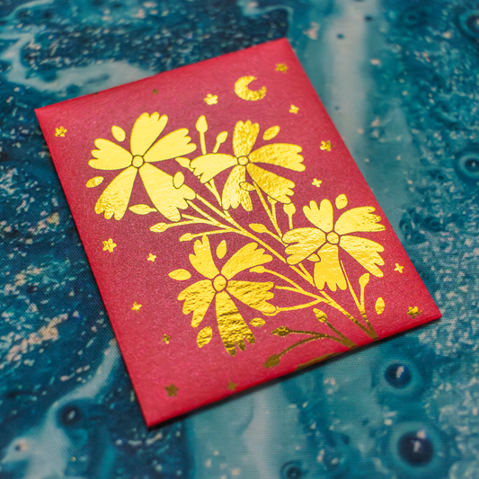 Red envelope with gold floral design on a blue textured background